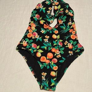 Size medium. One piece swimwear. NEW. Never worn